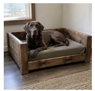 Tall post custom wood dog bed with a chocolate lab